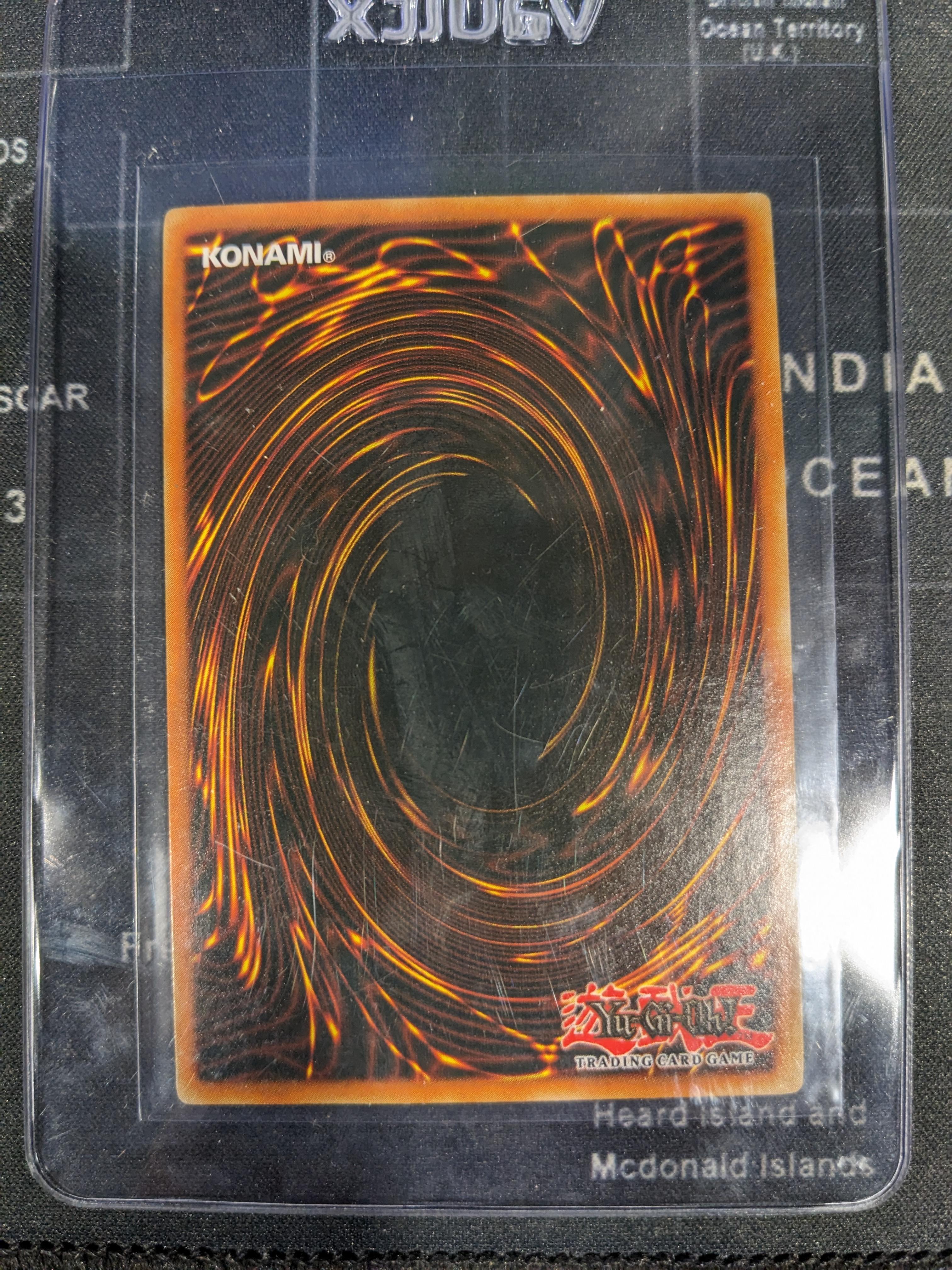 A close-up view of a Yu-Gi-Oh! card being inspected for grading quality.